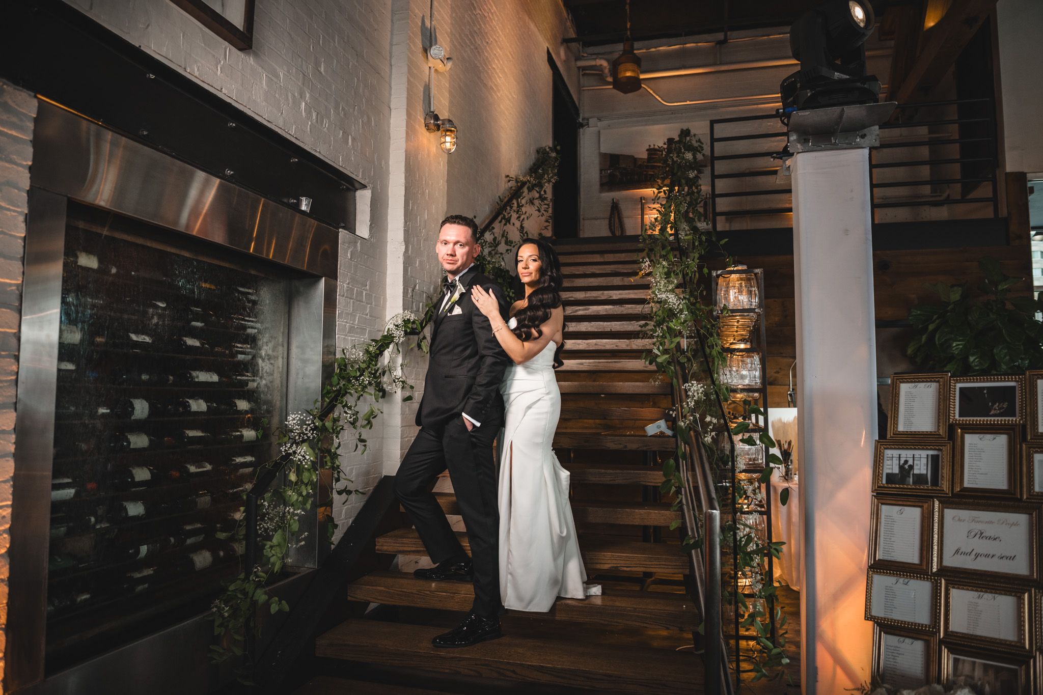 Modern industrial wedding venue interior with warm lighting and architectural details.