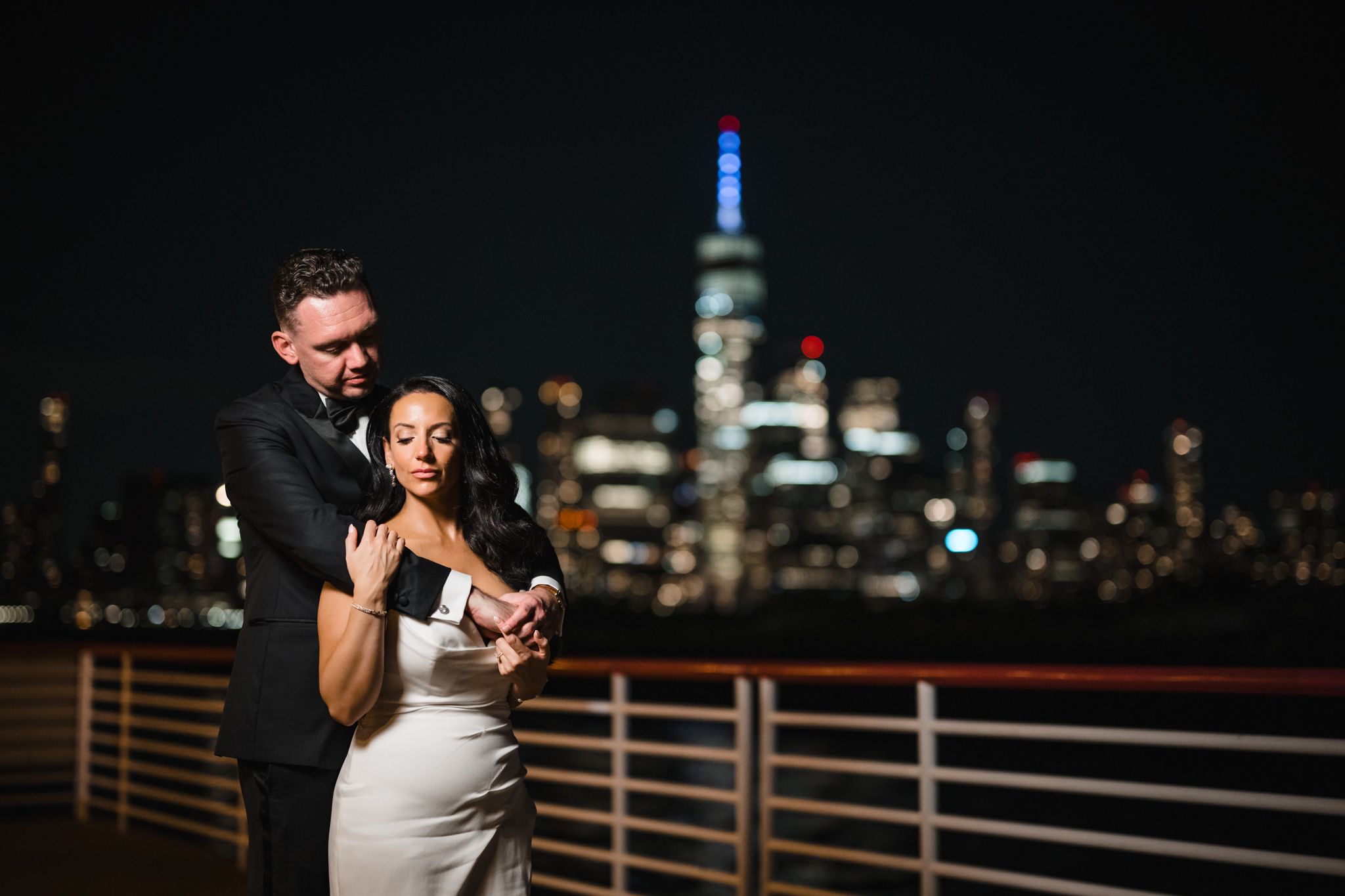Nighttime cityscape view from wedding venue with illuminated buildings in background.
