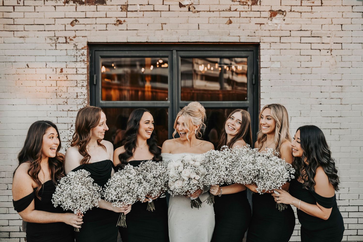 Candid sunset portraits of wedding party walking and laughing, editorial movement-focused imagery at Brake & Clutch Warehouse.
