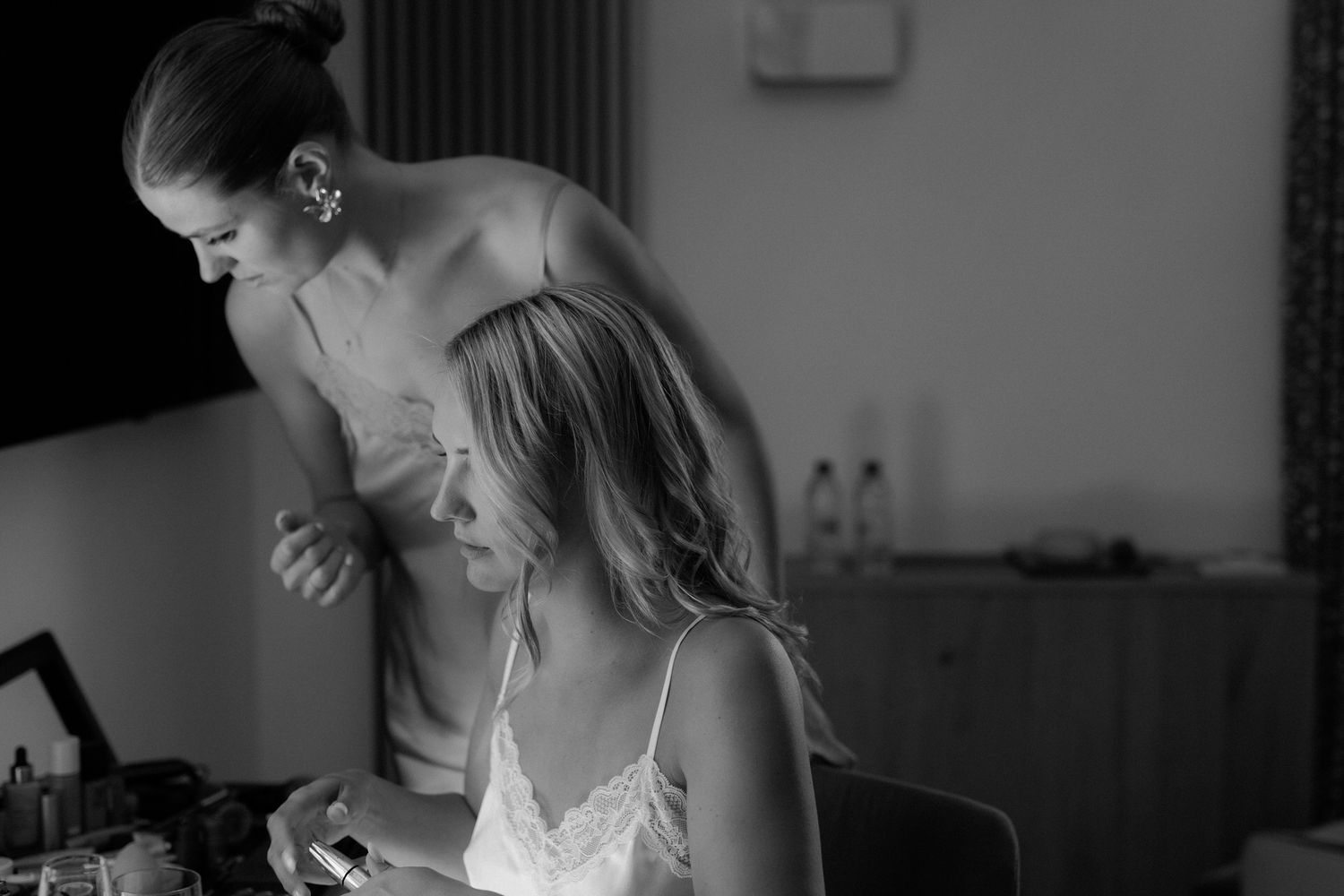 A series of black and white photos showing intimate moments at a wedding ceremony.