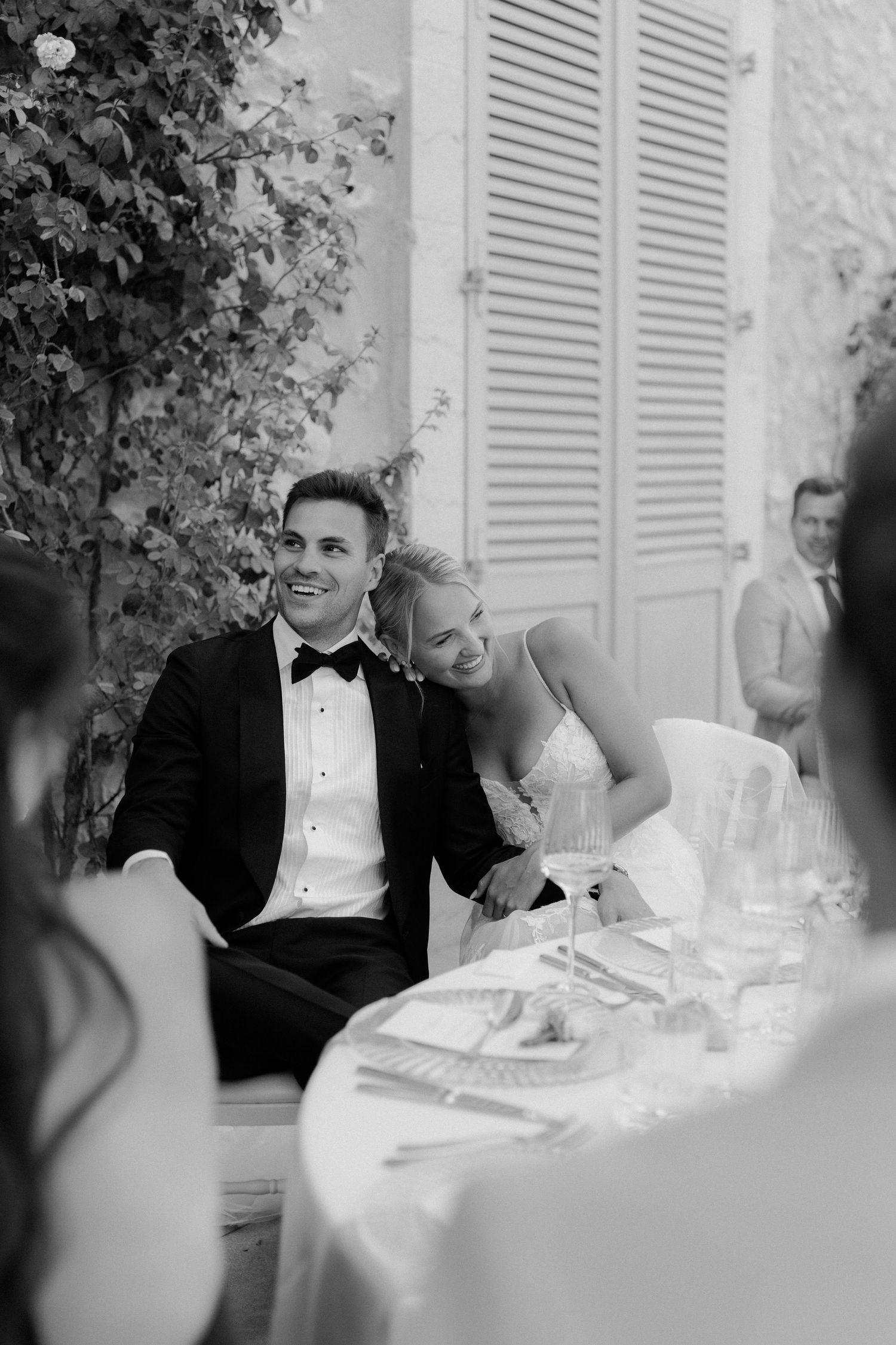 An elegant wedding scene with white parasols and outdoor lounge seating at a grand estate.