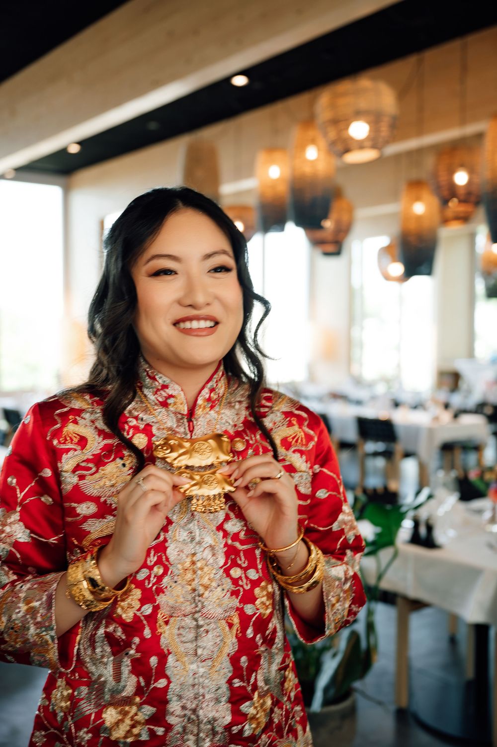 A sequence of photos showing someone wearing a traditional red Chinese qipao dress with gold embroidery in an indoor setting.