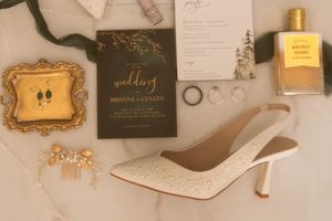 Wedding stationery and decorative elements arranged on a light colored surface.