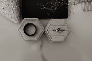 Geometric hexagonal wall art pieces in white and gray tones arranged on a wall.