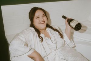 Candid moment showing someone in white relaxing with a bottle.