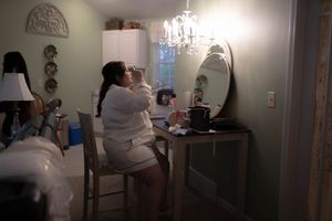 Medical professionals in white uniforms working in a clinical setting.