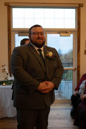 Wedding ceremony venue with large windows and natural light filtering through.