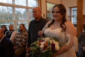 Wedding guests gathered in a warmly lit room with wooden architectural details.