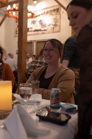 Reception guests socializing at tables with glowing candles and Diet Mountain Dew.