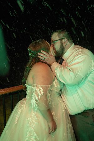 A romantic dance moment between newlyweds in a lace wedding dress and white shirt.