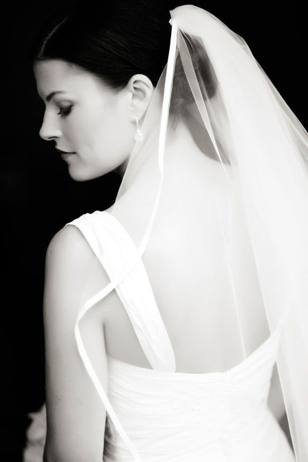 A series of artistic black and white bridal portraits showing the elegant flow of a wedding veil against dark background.