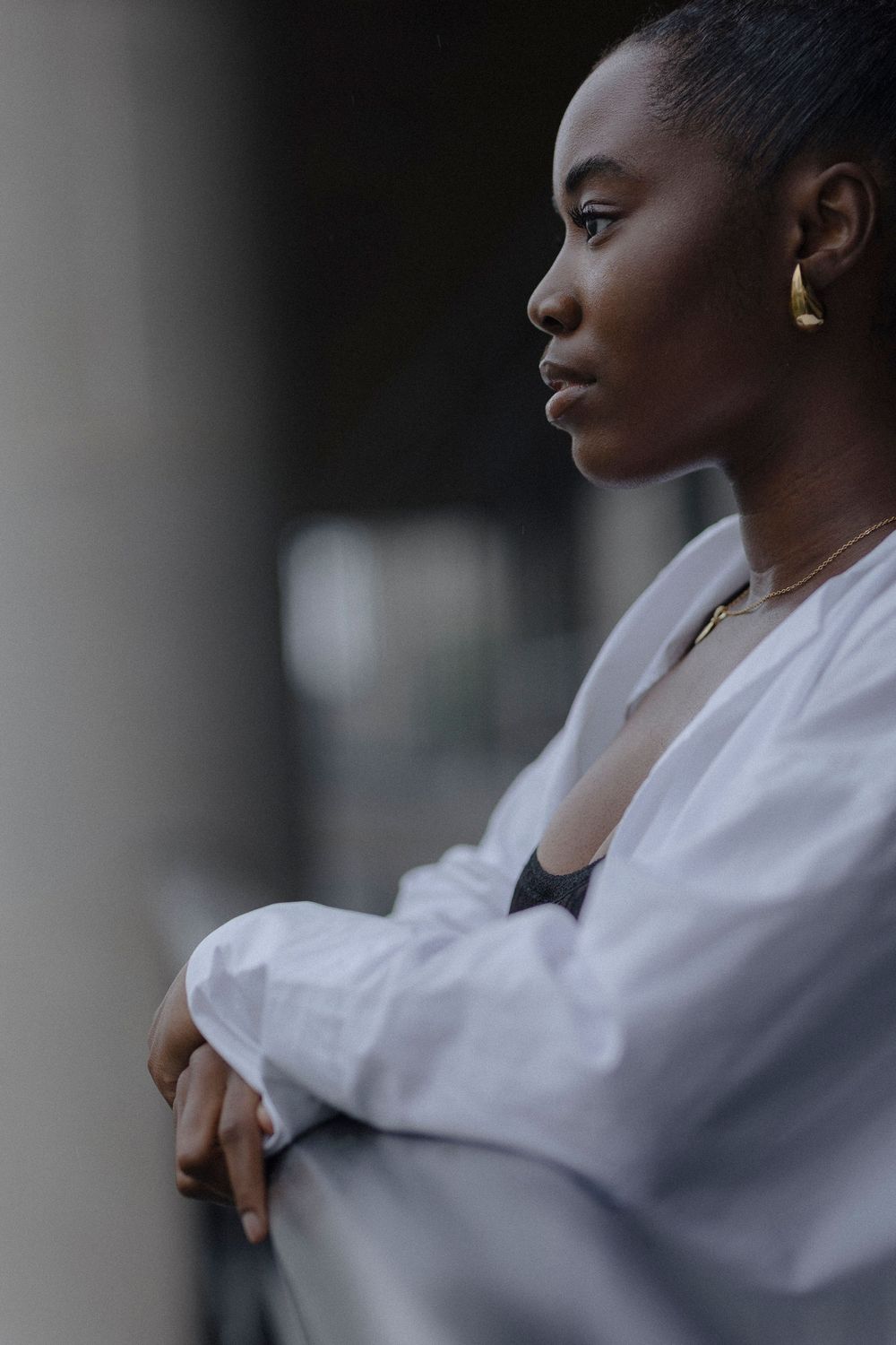 Side profile portraits showing someone in a white shirt looking contemplative against a dark background.