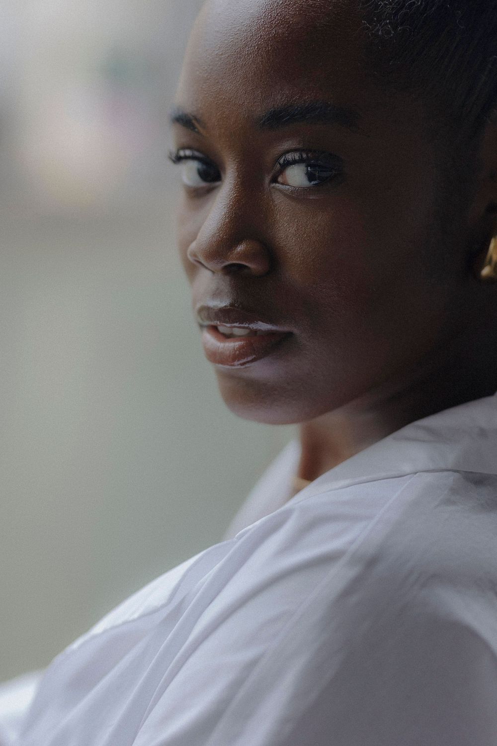 A series of profile portraits showing a figure in a white shirt against a soft, blurred background.