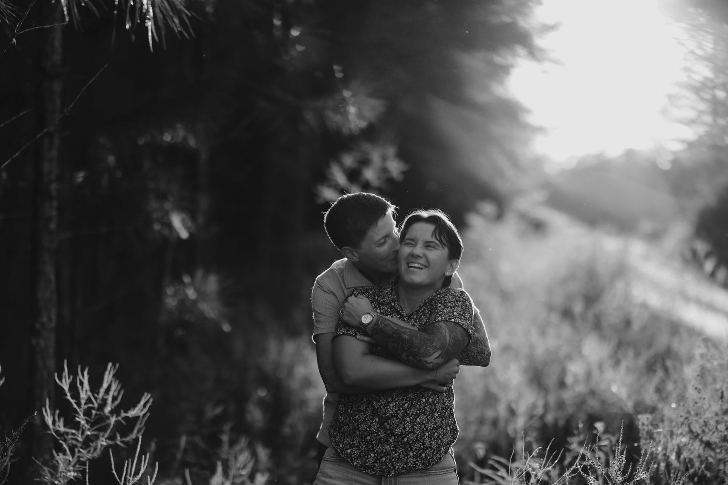 A collection of black and white outdoor photography images showing couples in romantic poses and natural settings.