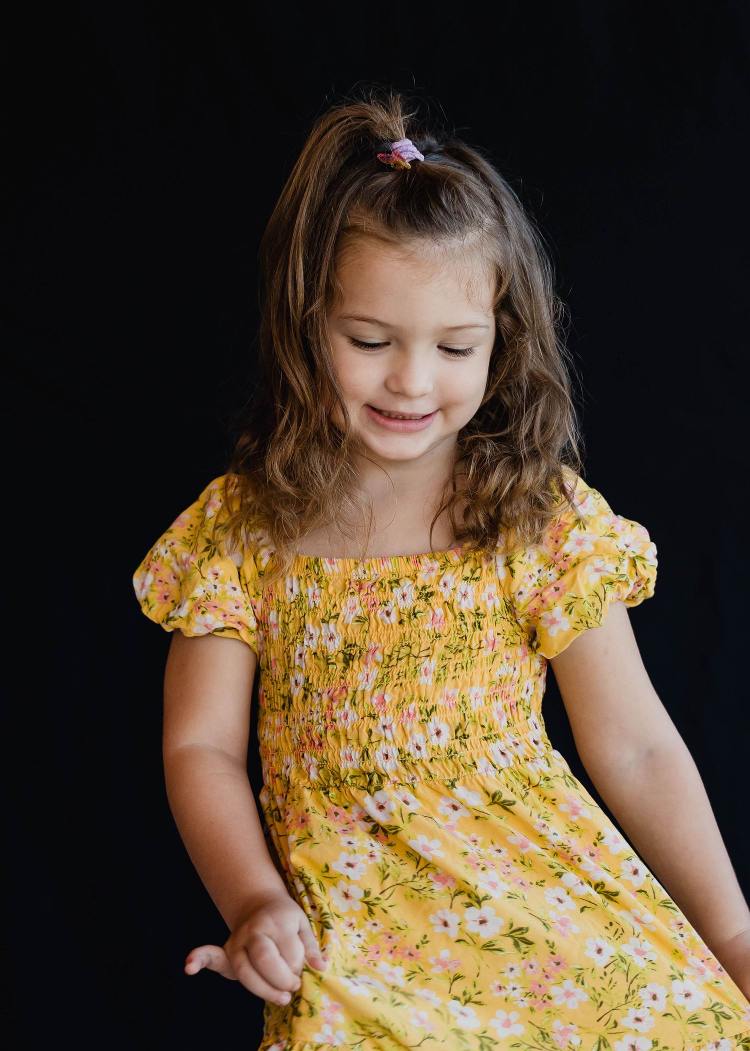 Girl playing before her preschool portrait in a Montessori classroom in Brevard County.