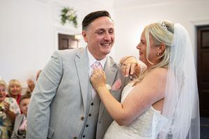 Wedding celebration with joyful moments captured in elegant indoor setting.
