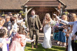Outdoor wedding celebration with guests in spring garden setting.