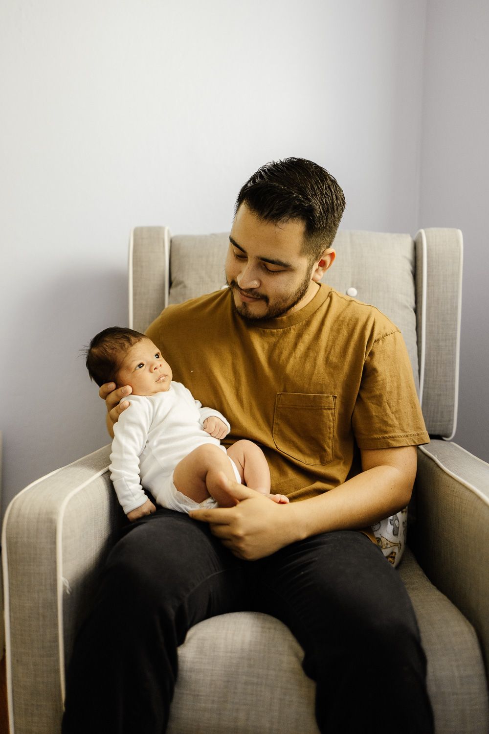 Dad holds baby at newborn session with Bay Area Newborn Photographer Cindy Tucey in Campbell