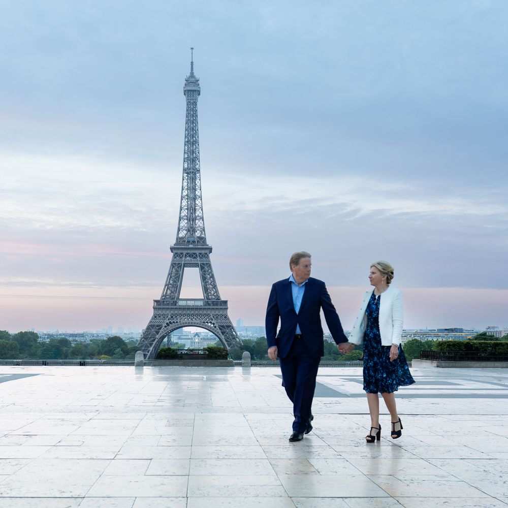 Couple walking along the trocadero in Paris with Eiffel Tower in background