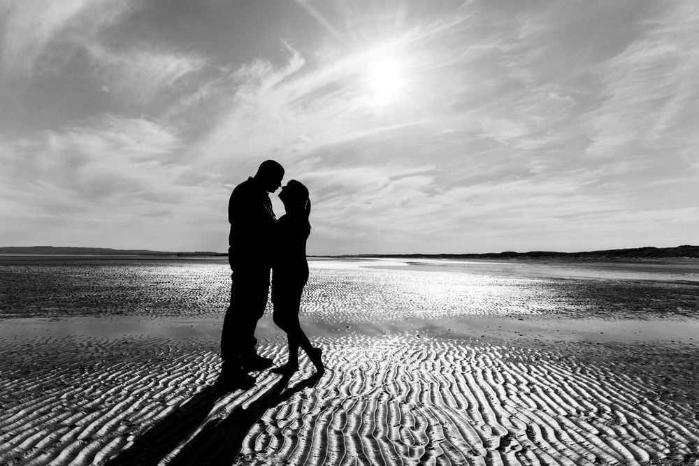 Silhouette of couple on Kent beach | Camber Sands