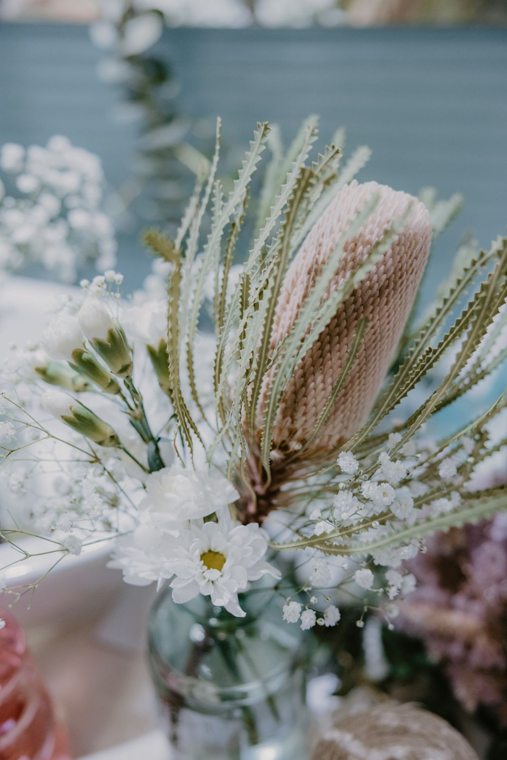 Native flowers in a vase being prepared for wedding reception