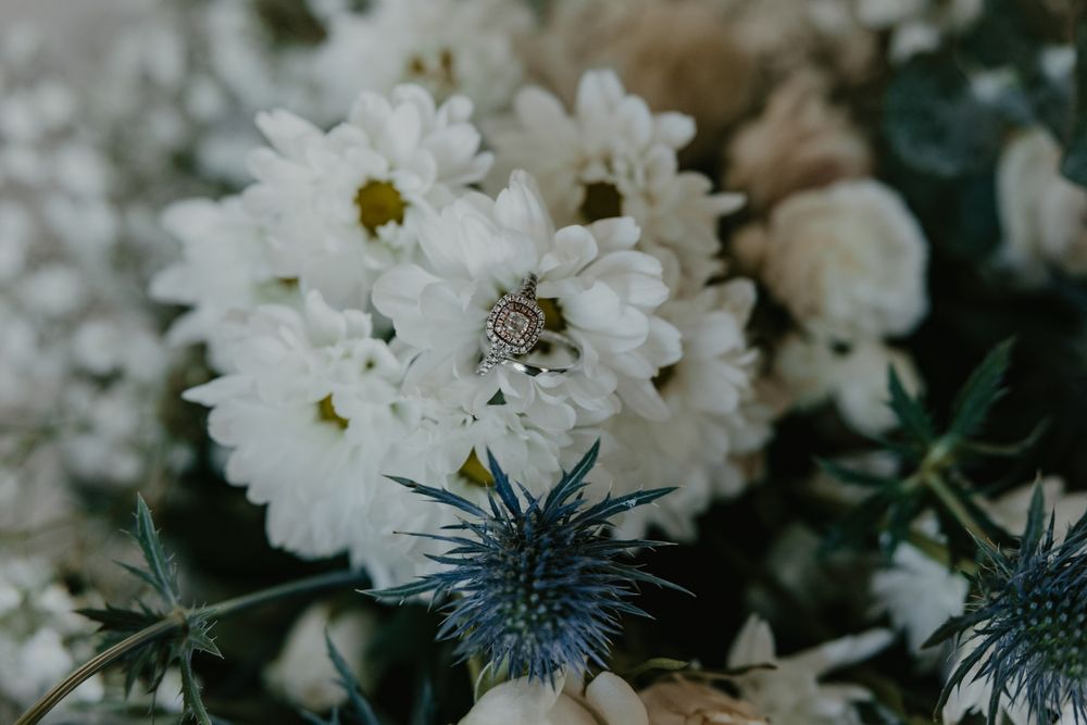 Close up of brides wedding bouquet with engagement ring in one of the flowers