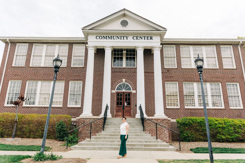 Exterior view of Matthews community center building with white columns and traditional colonial architecture style during senior portraits