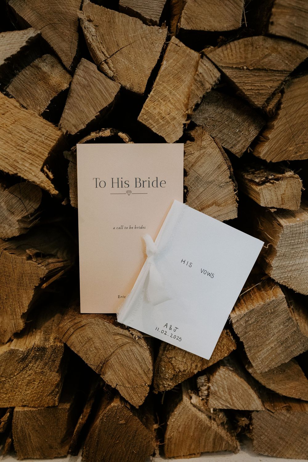 Wedding letters and envelopes arranged on rustic wooden logs background.