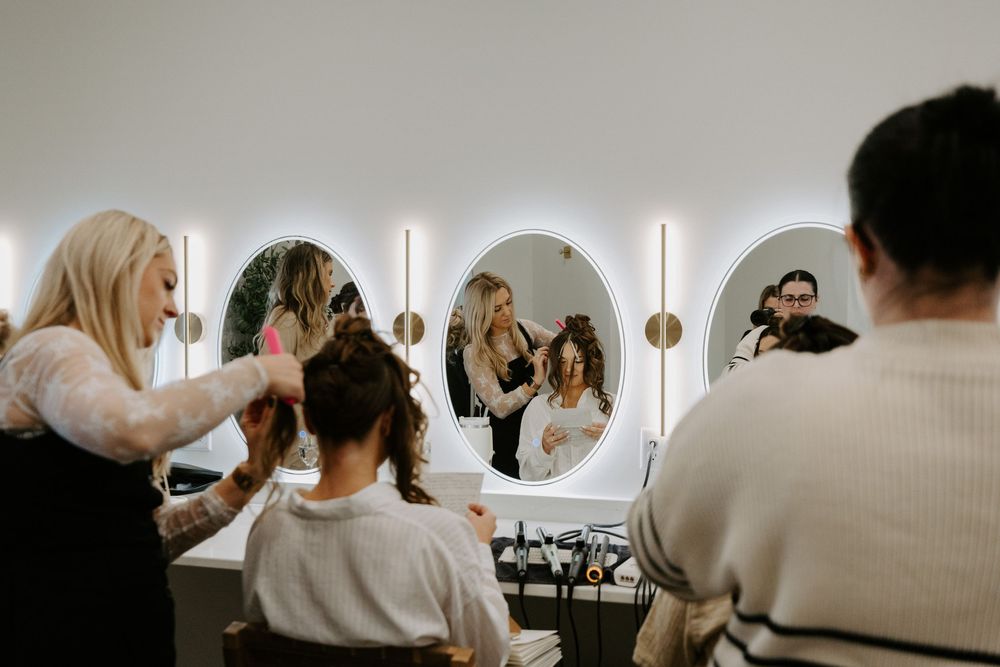 Wedding preparation scene in a bright white modern room with guests.