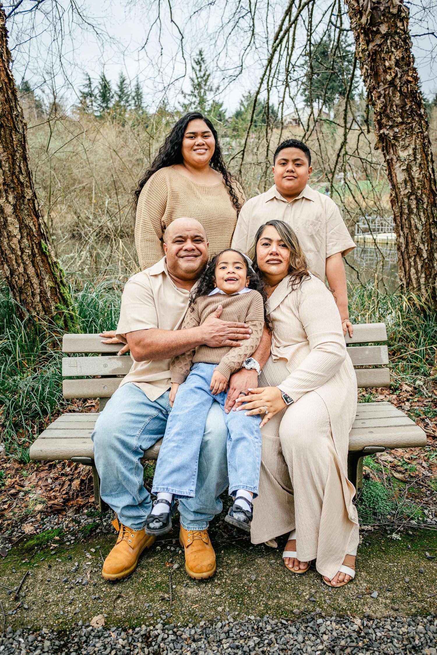 Family of five sitting together on a bench during a January family photo session in Puyallup, Washington