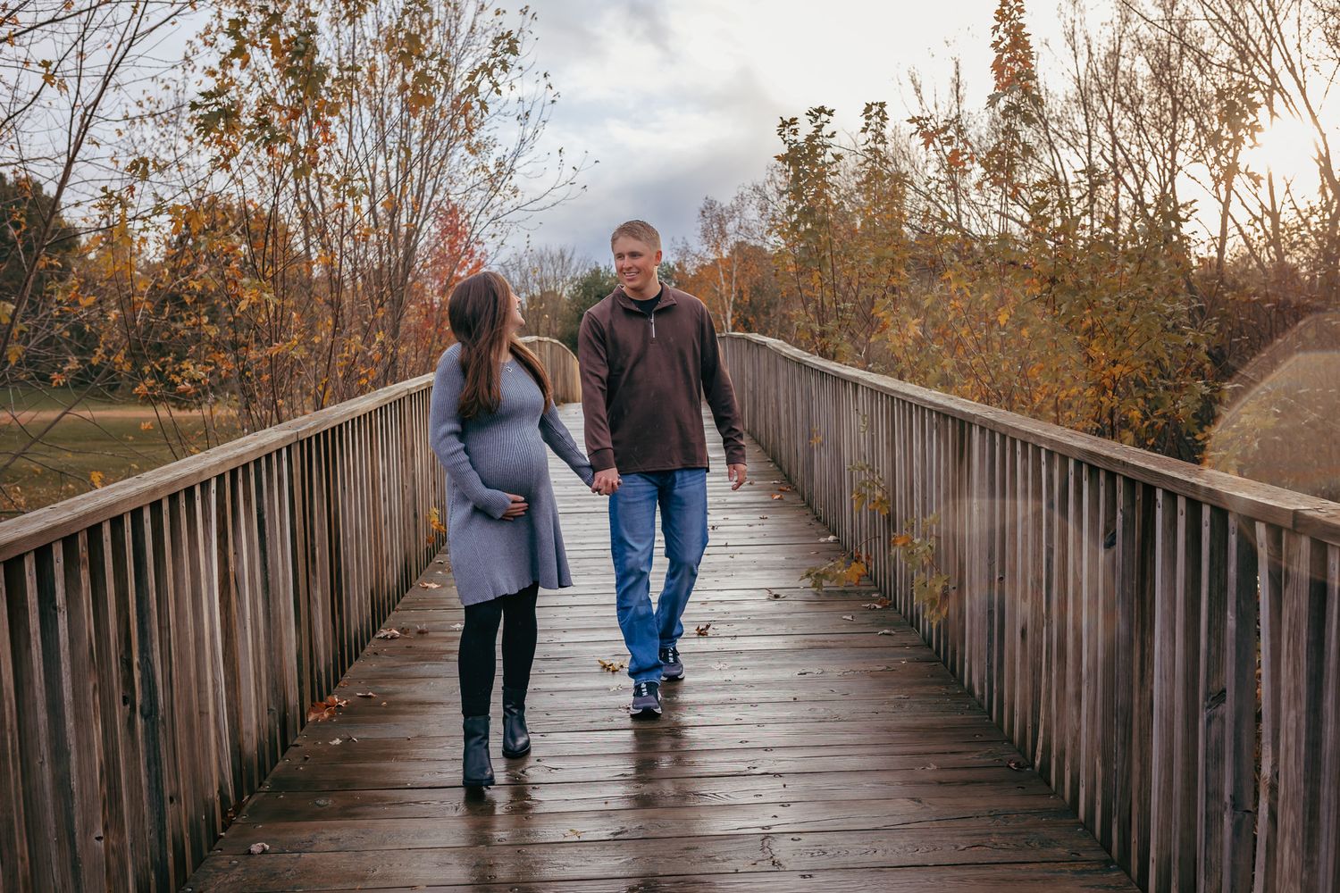 Mom and dad laughing together during their precious maternity session