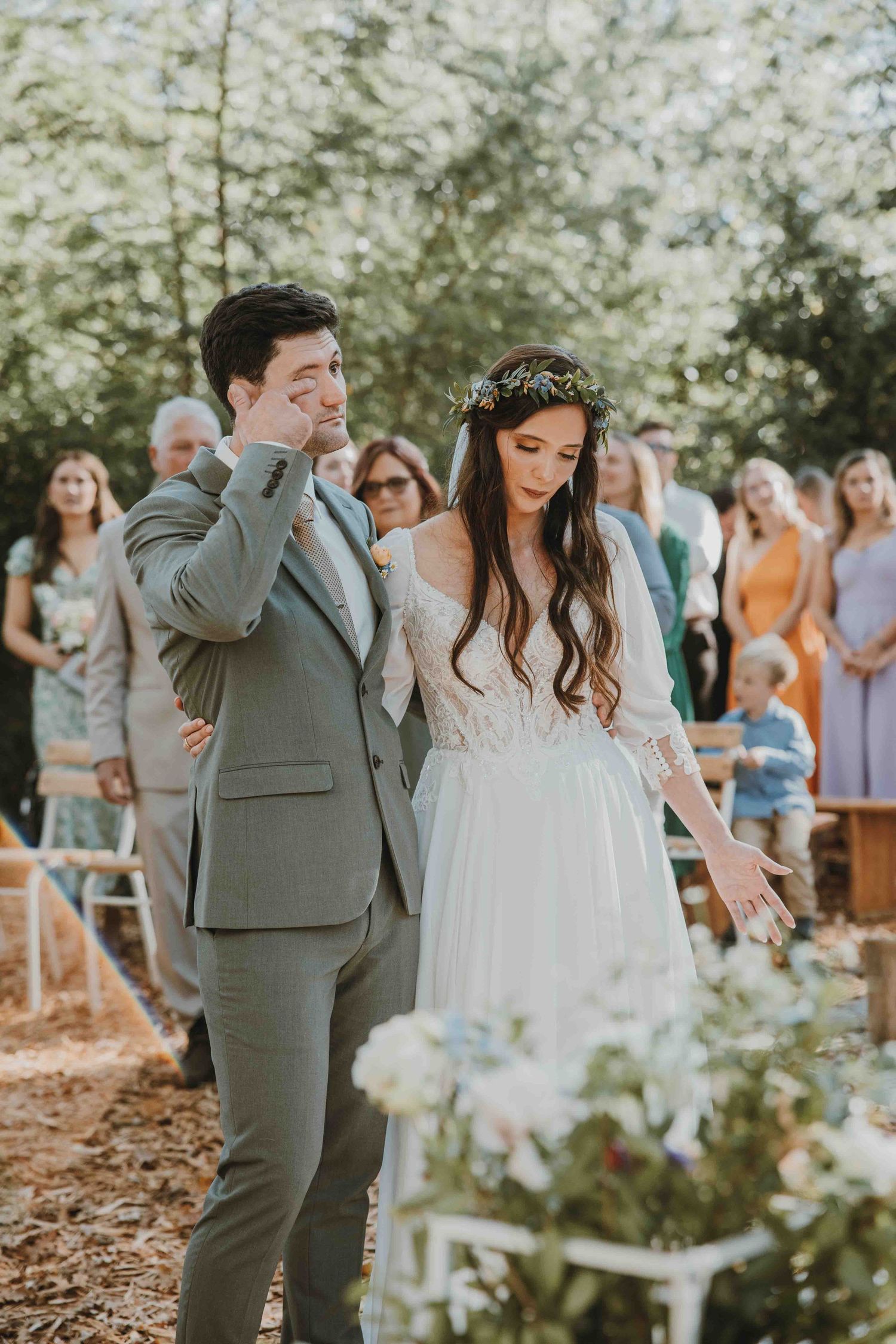 A playful sequence of groomsmen lifting and tossing the groom in celebration during an outdoor wedding photoshoot.