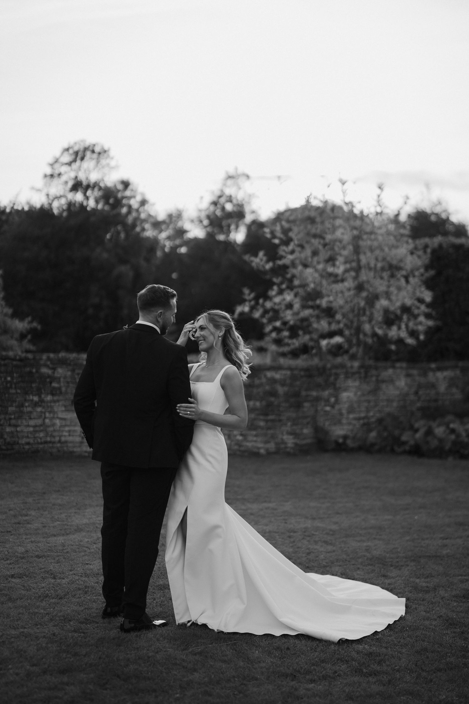 bride and groom smiling at each other at ivy lodge wedding in cirencester