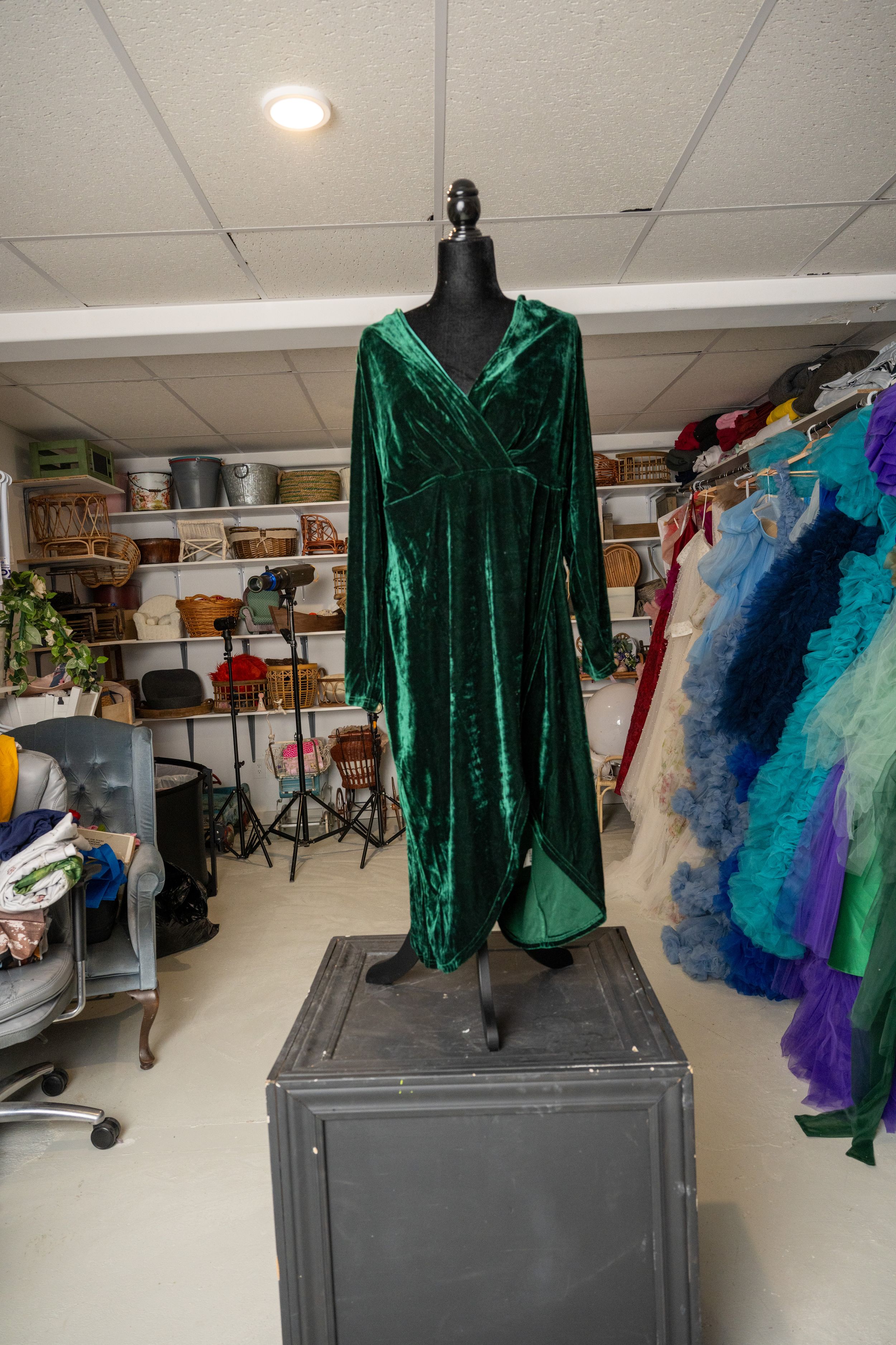 Emerald green velvet top displayed on mannequin with multiple angles showing sleeves and neckline details.