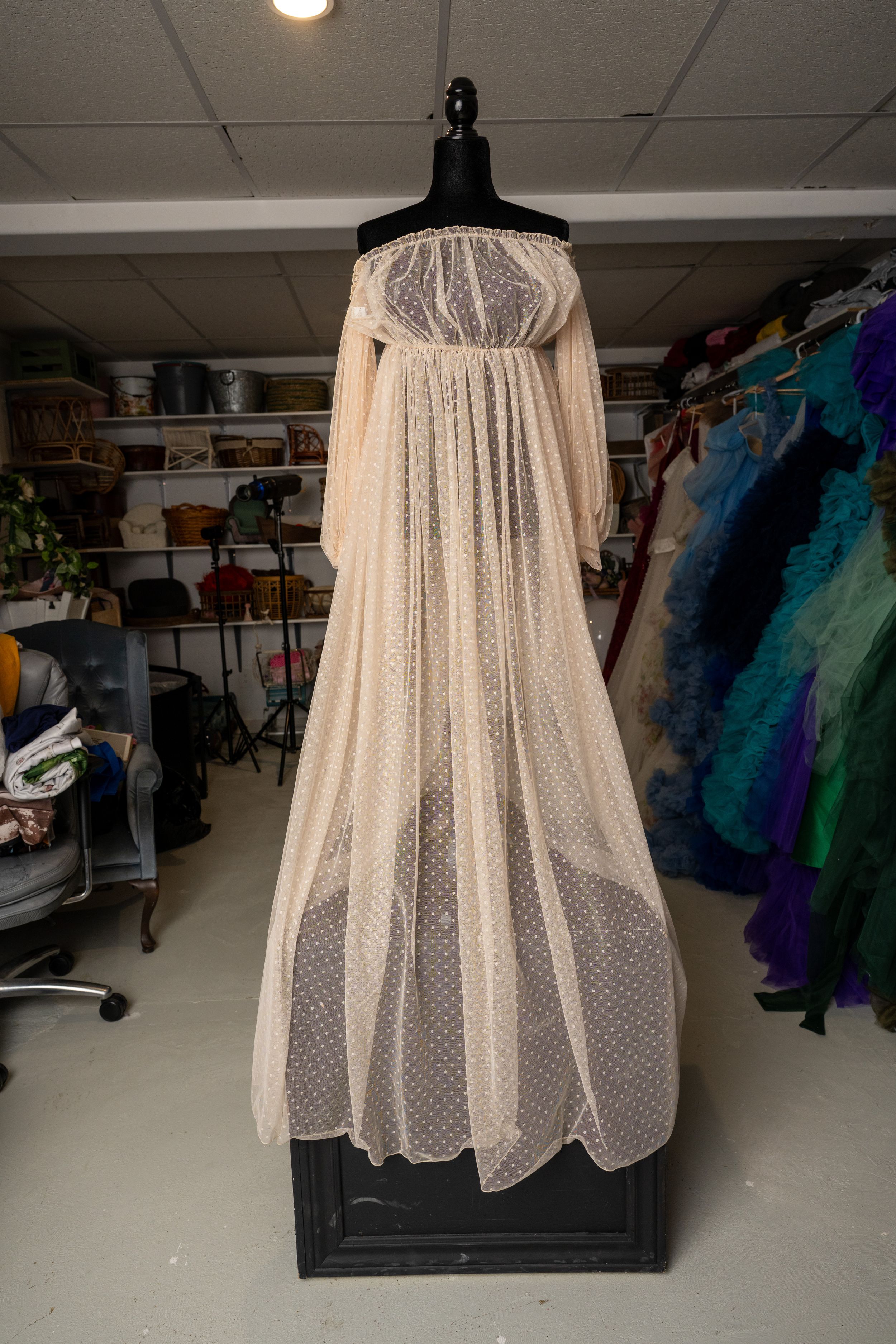 A series of photos showing a sheer white polka dot petticoat dress displayed on a black hanger in a storage room.