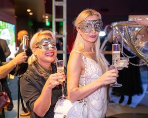 Group enjoying wine and champagne at an elegant evening event with sparkling glasses.