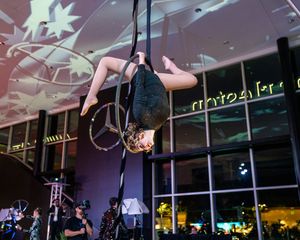 A modern indoor venue space with decorative white antler-like lighting fixtures suspended from the ceiling.