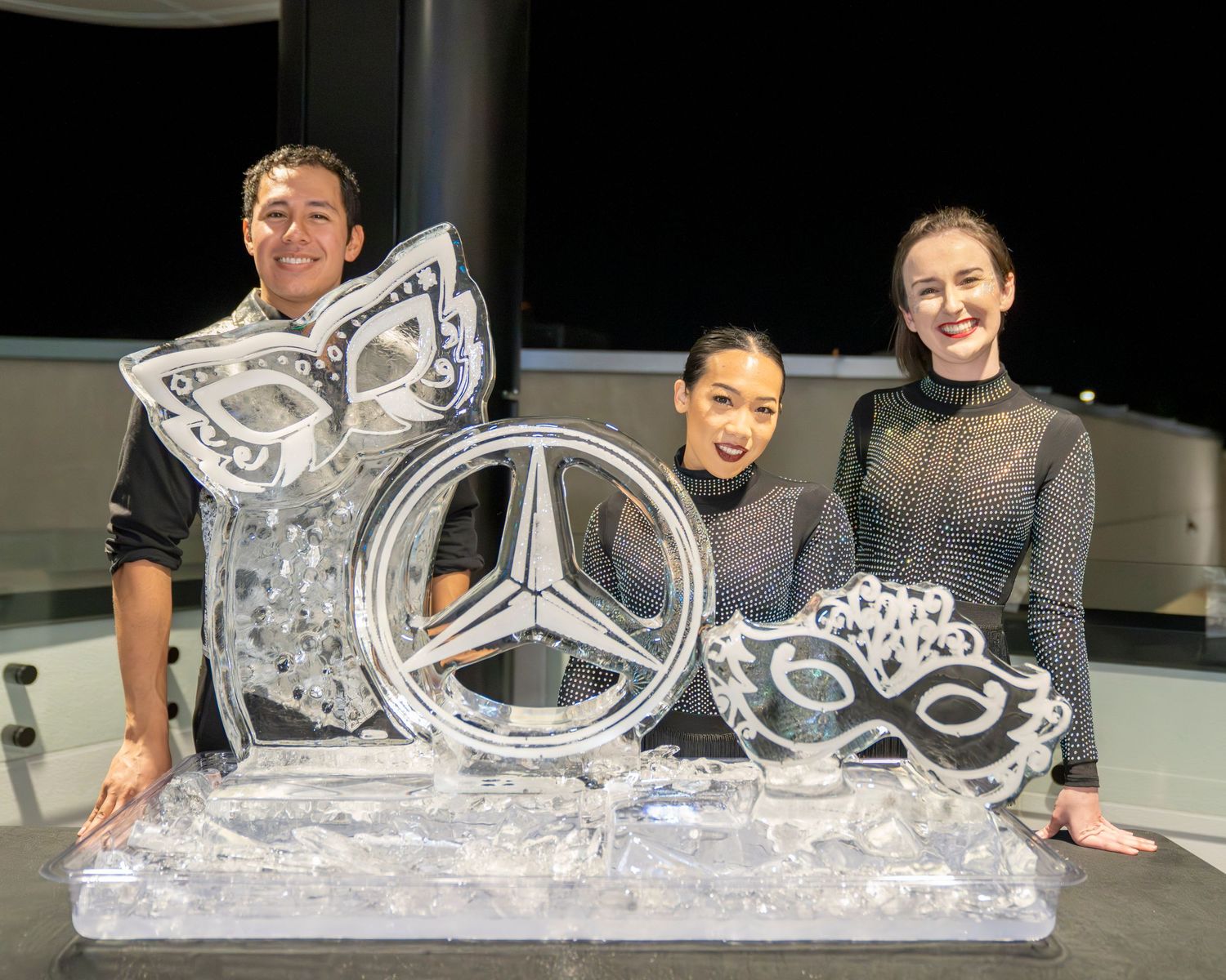 Large decorative ice sculpture display on a table with intricate carved designs.