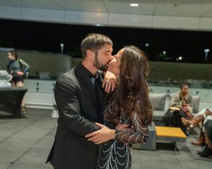 A sequence of romantic dance moves between two people in a dimly lit space.