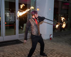 Fire performer demonstrates spinning techniques in a nighttime outdoor performance sequence.