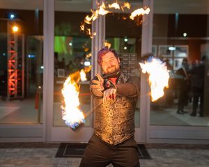 A sequence of fire performance shots showing dramatic flame effects in an urban setting at night.