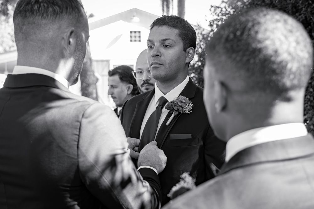 A series of black and white candid photos showing guests interacting at a formal event.