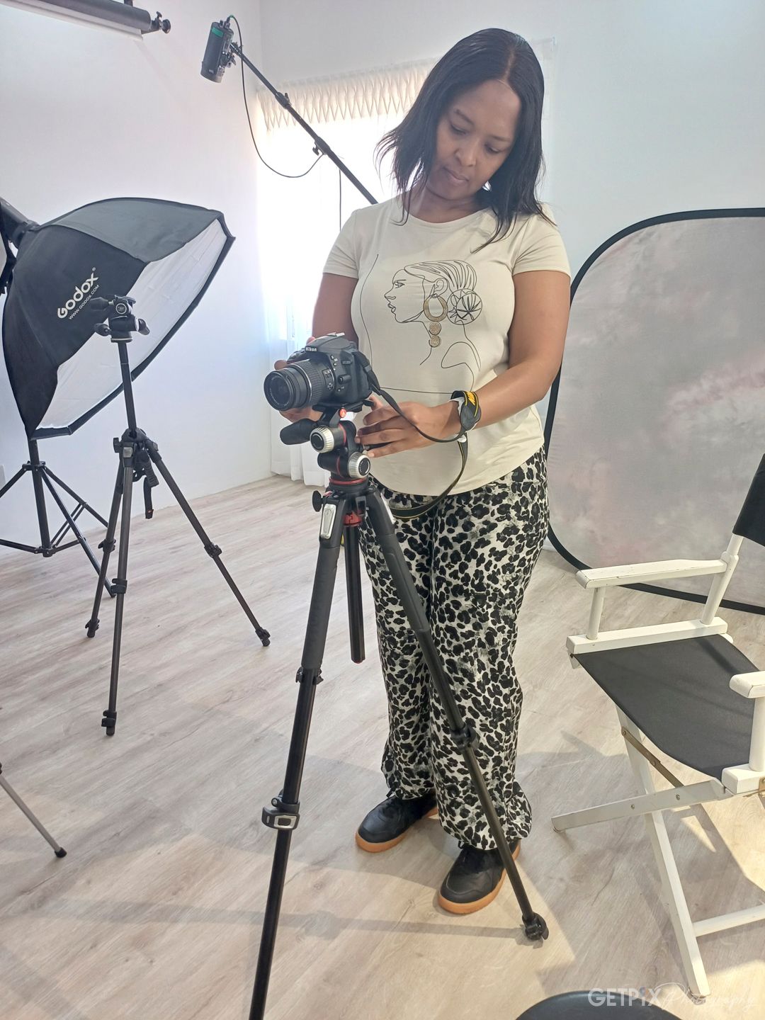 Student developing technical skills in studio photography, mastering lighting, exposure, and camera operation on GETPIX course.