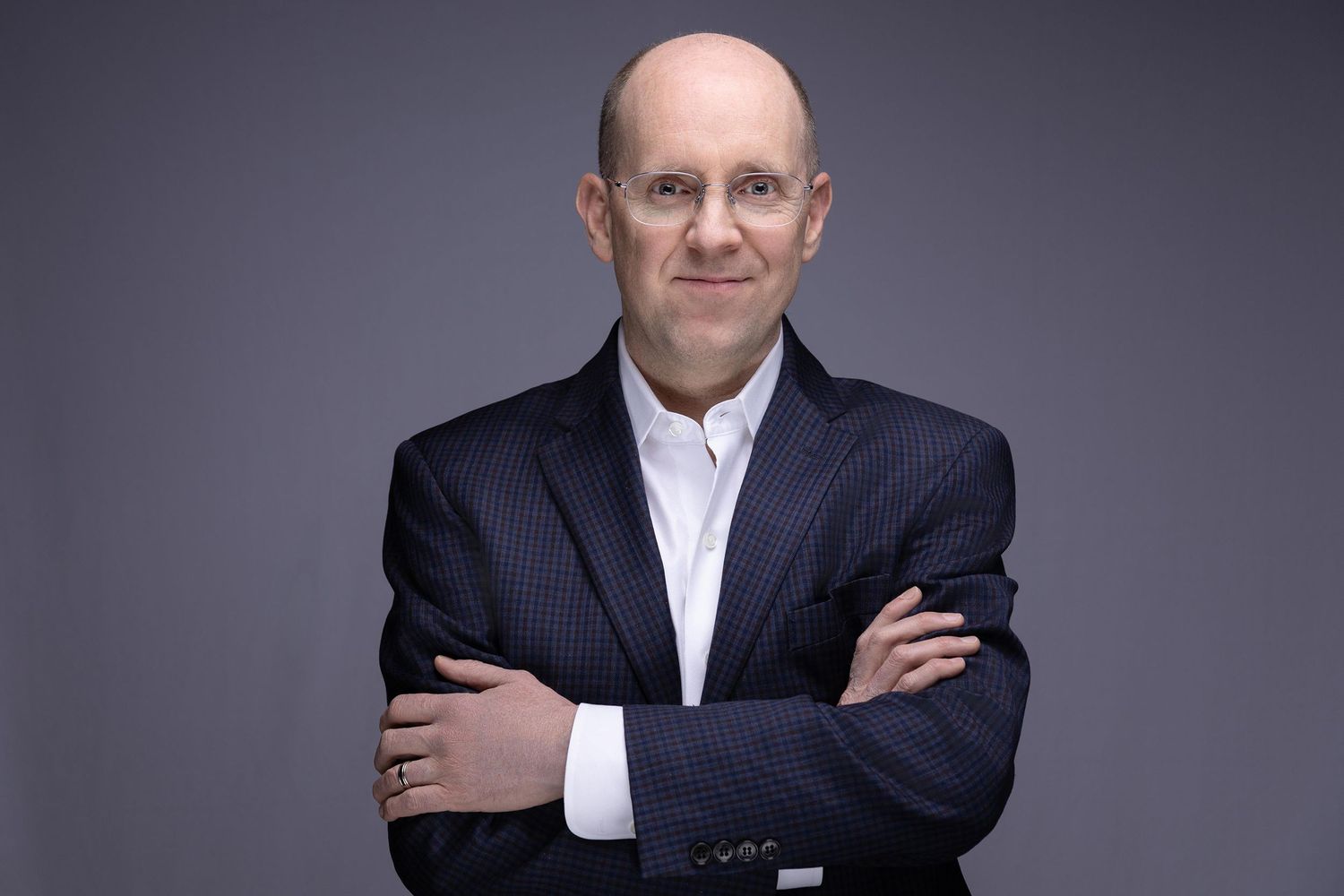 Professional headshot of a male executive with natural expression