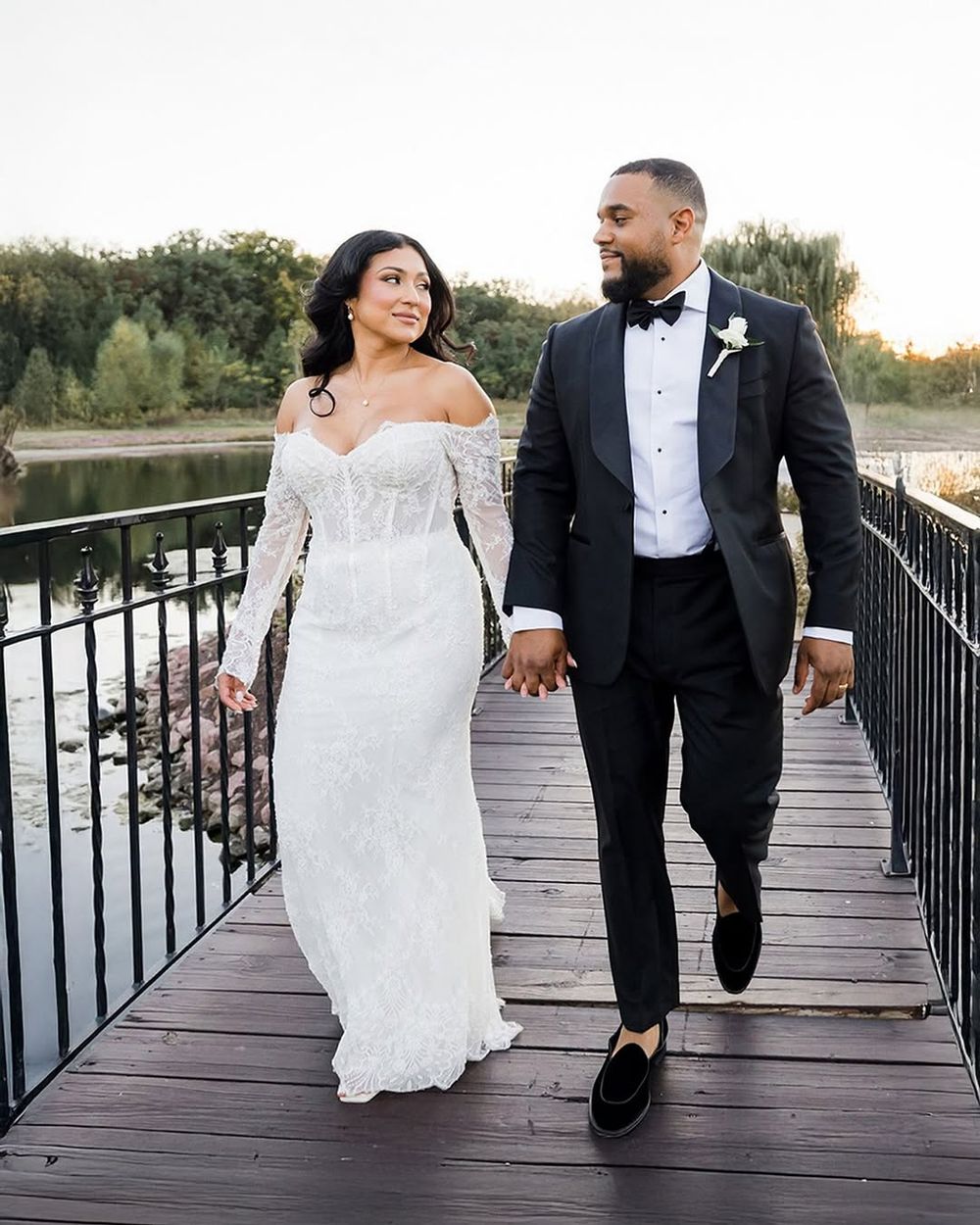 A bride and groom hold hands while walking on a wooden bridge during sunset, shown in multiple candid shots.