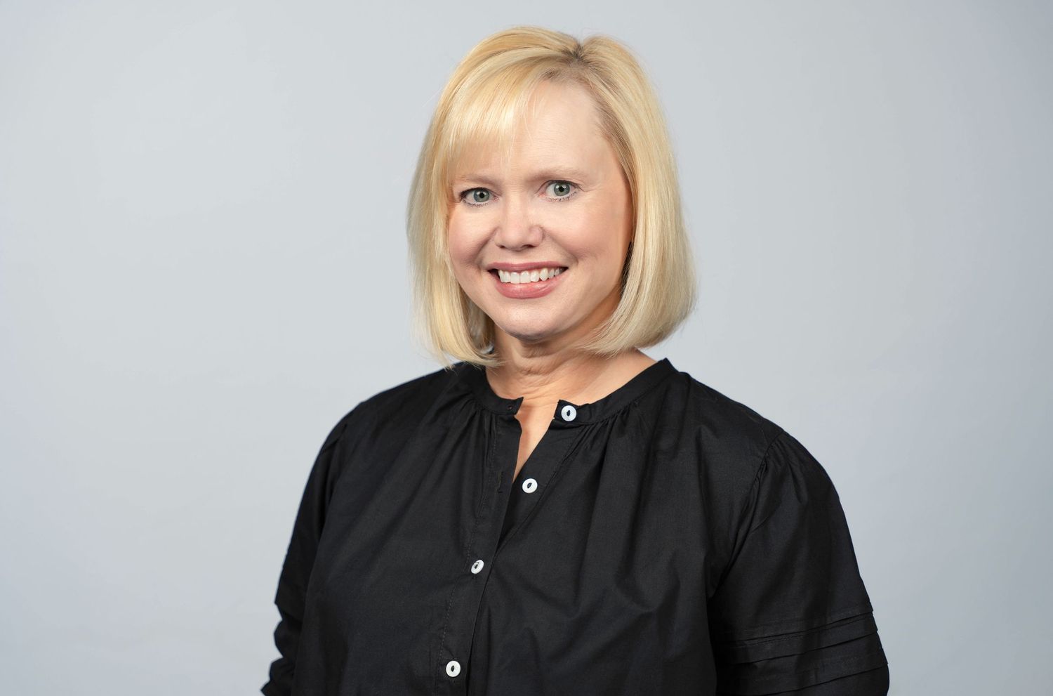 headshot of a woman smiling at the camera