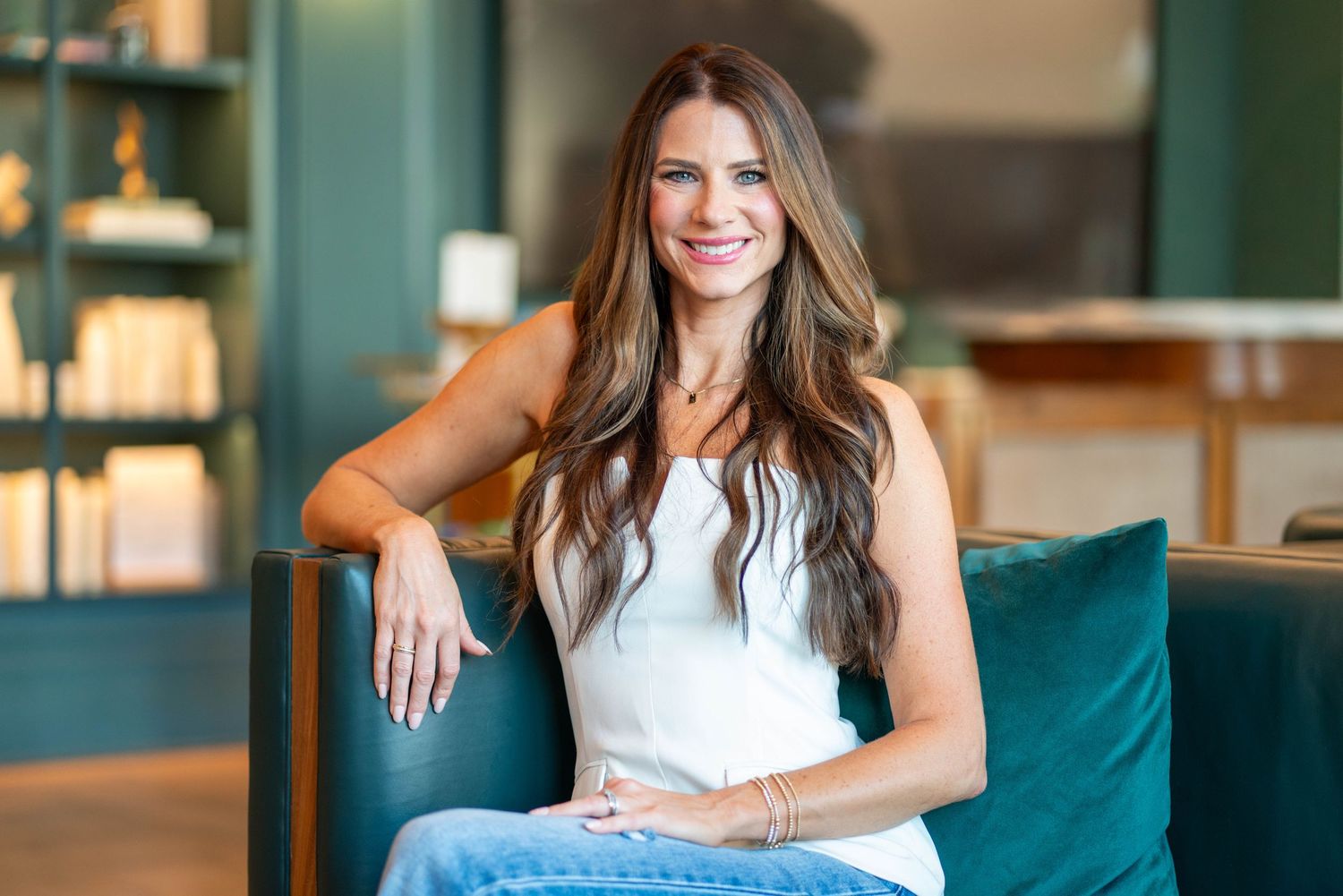 female real estate agent sitting, smiling at the camera