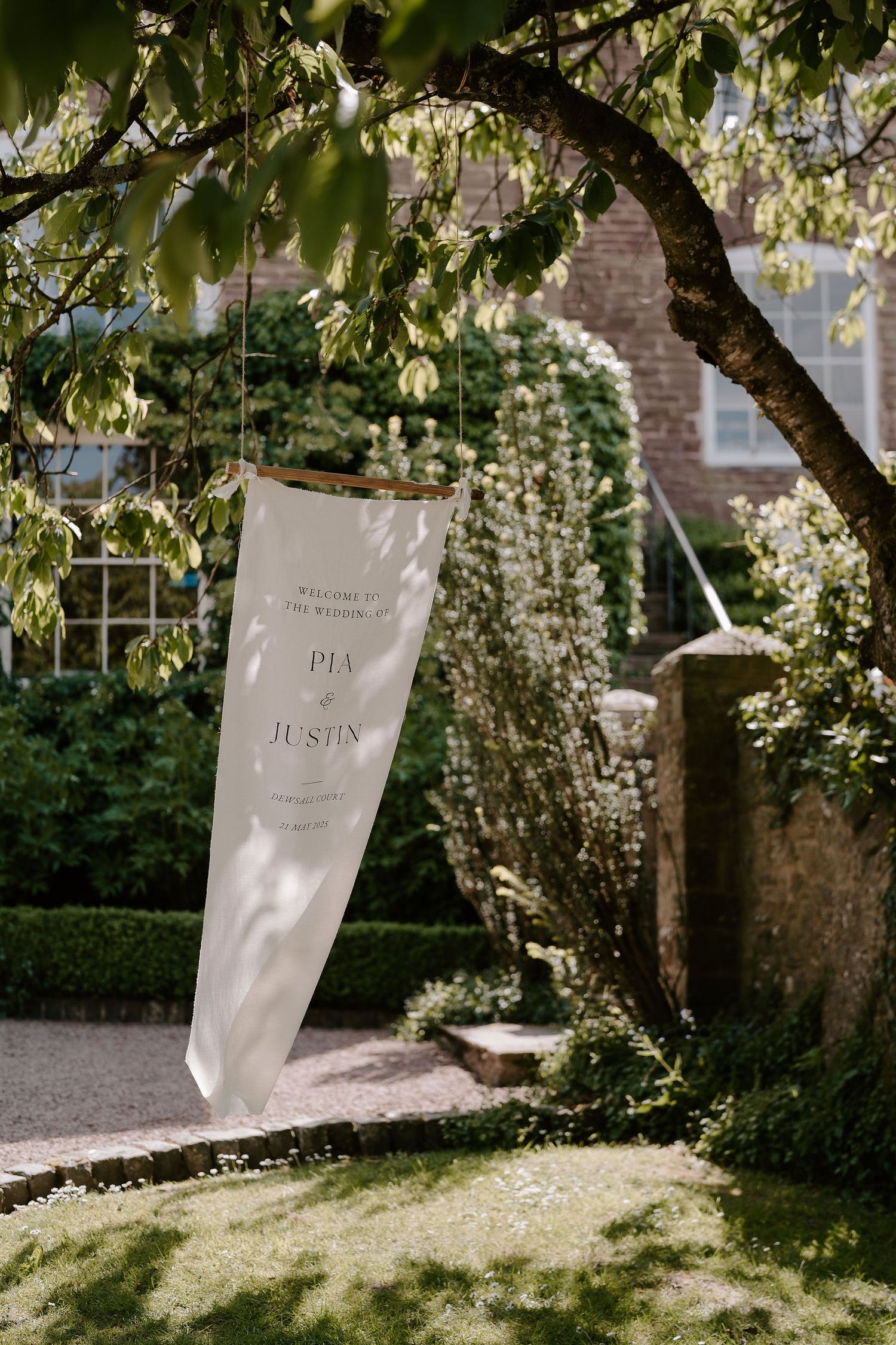 welcome sign hanging off tree branch, blowing in the breeze at dewsall court in herefordshire