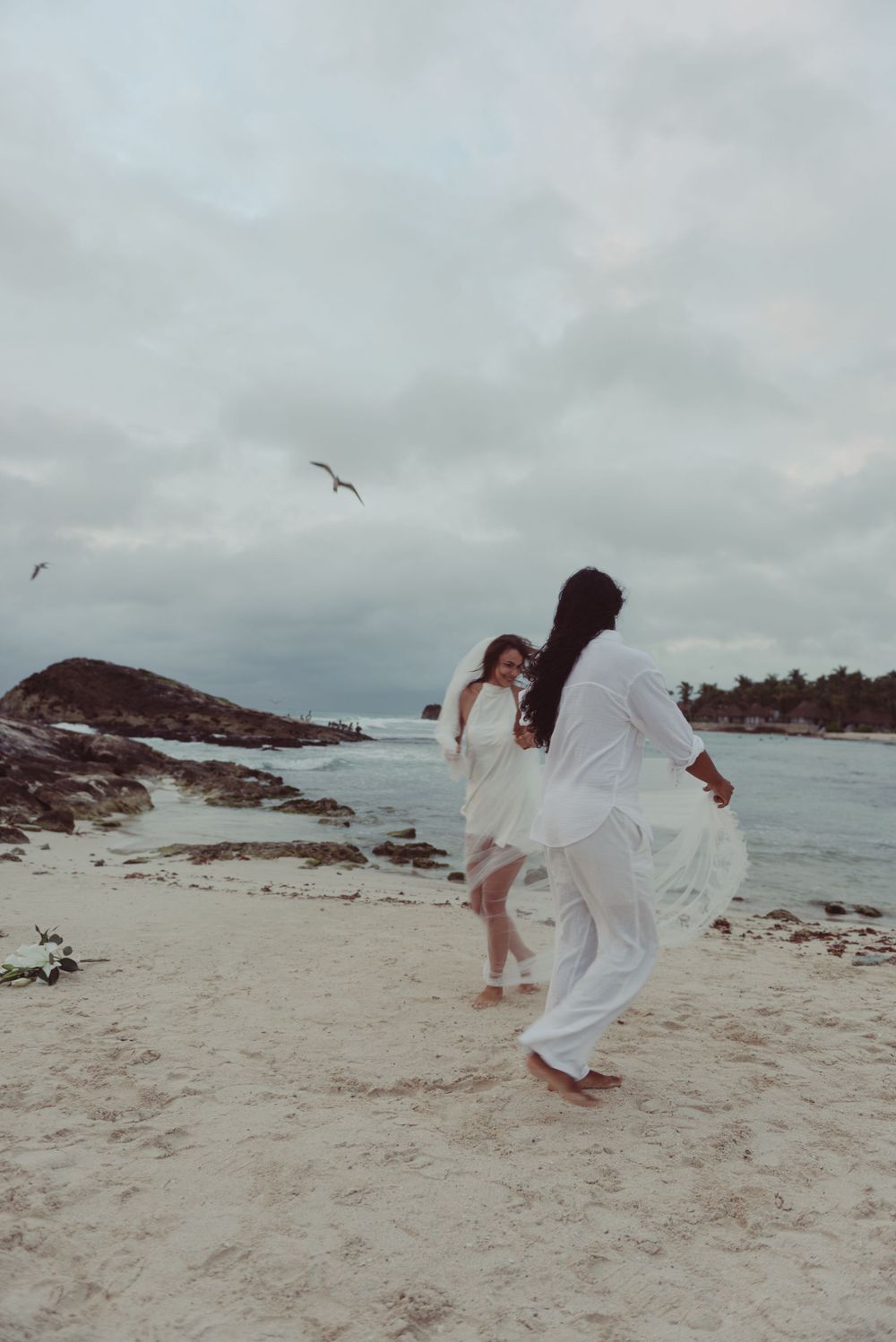 Romantic couple dancing on the beach in Tulum, Mexico.