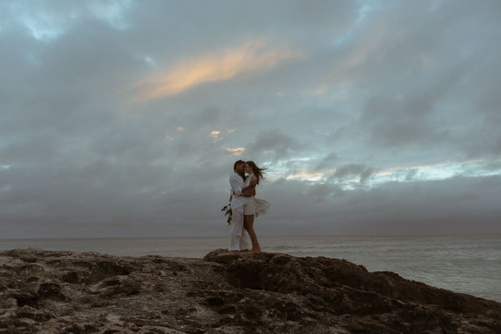 A bride and groom embrace at sunrise during their elopement in Tulum, Mexico.